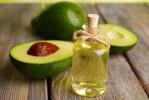 A bottle of avocado oil and some avocado.