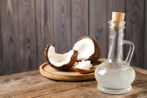A bottle of coconut oil and a chopped coconut.