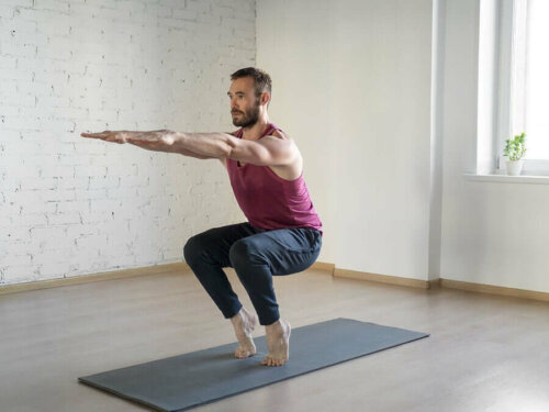 A man doing yoga on his tip toes.
