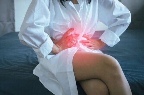 A person holding on to their stomach because of a discomfort.