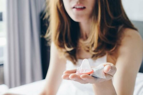 A woman with a condom in her hand.