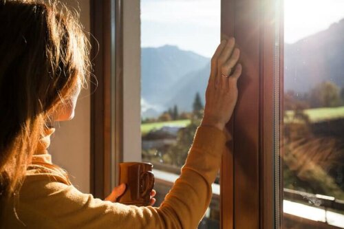 A woman looking out the window because she's alone.