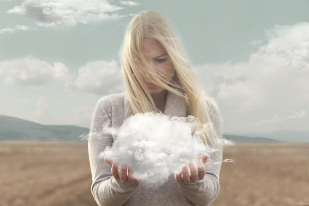 Woman looking at cloud in her hands