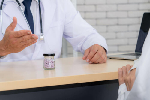 doctor and patient talking sat at a table