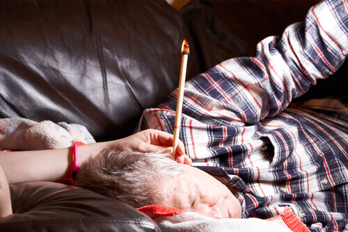 a man having ear candling performed on him