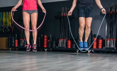 a man and a woman jumping rope to get rid of loose skin after losing weight