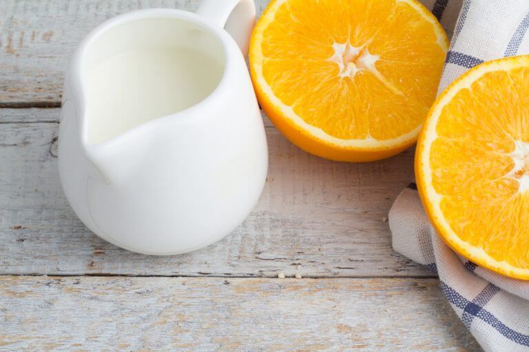 orange halves and a small jar with milk