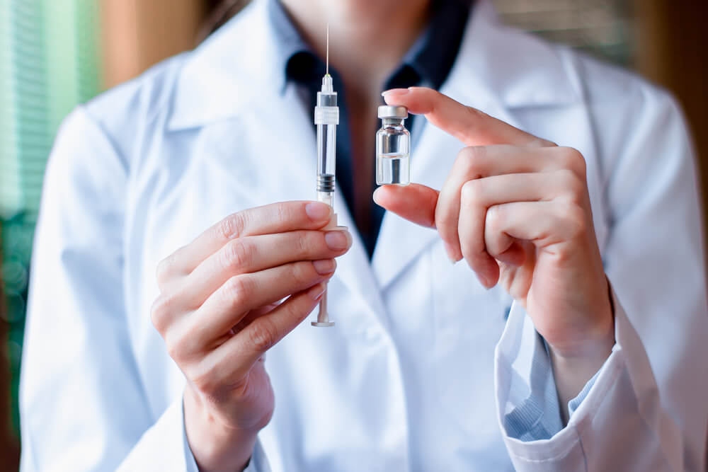 A doctor with an HPV vaccine.