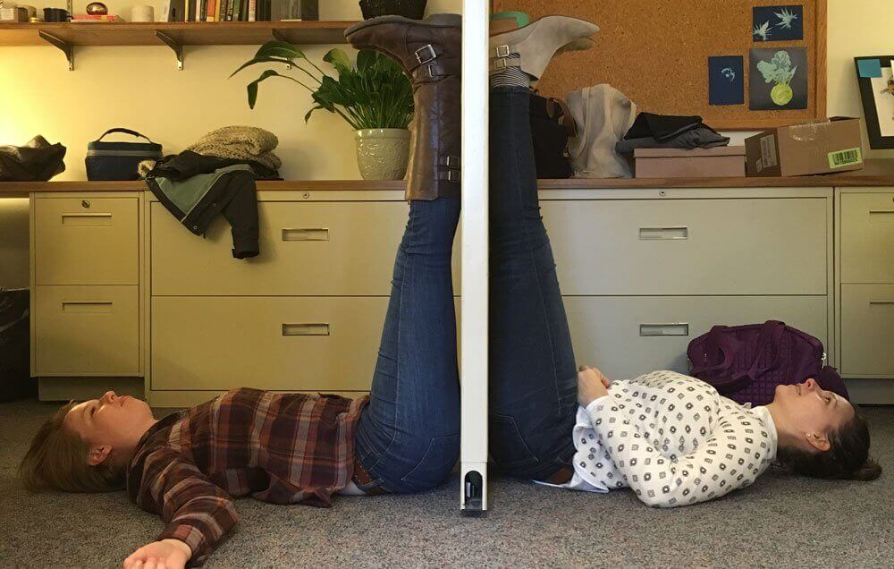 Two people discovering benefits of elevating your legs