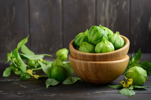 A couple stacked bowls with tomatillos.