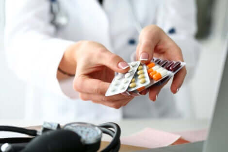 A doctor holding medications.