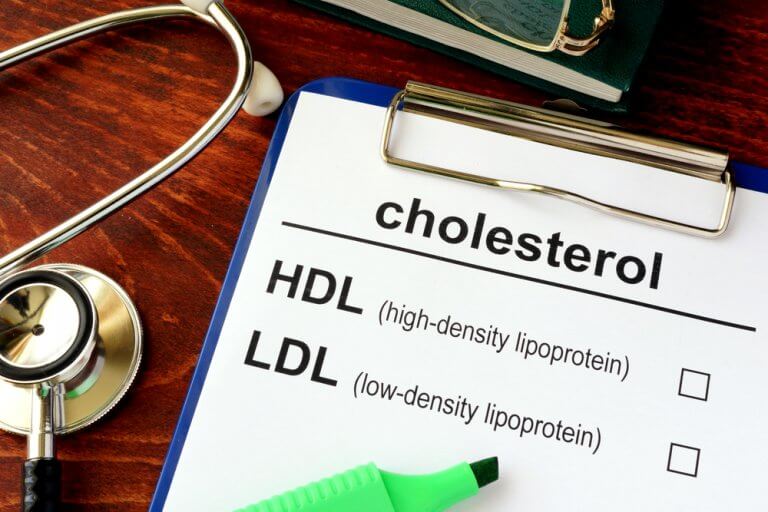 Clipboard on a doctor's desk with a paper about cholesterol