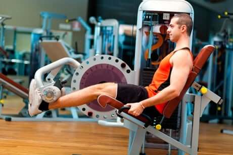 A man doing leg extensions.