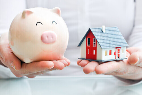 a piggy bank next to a small house