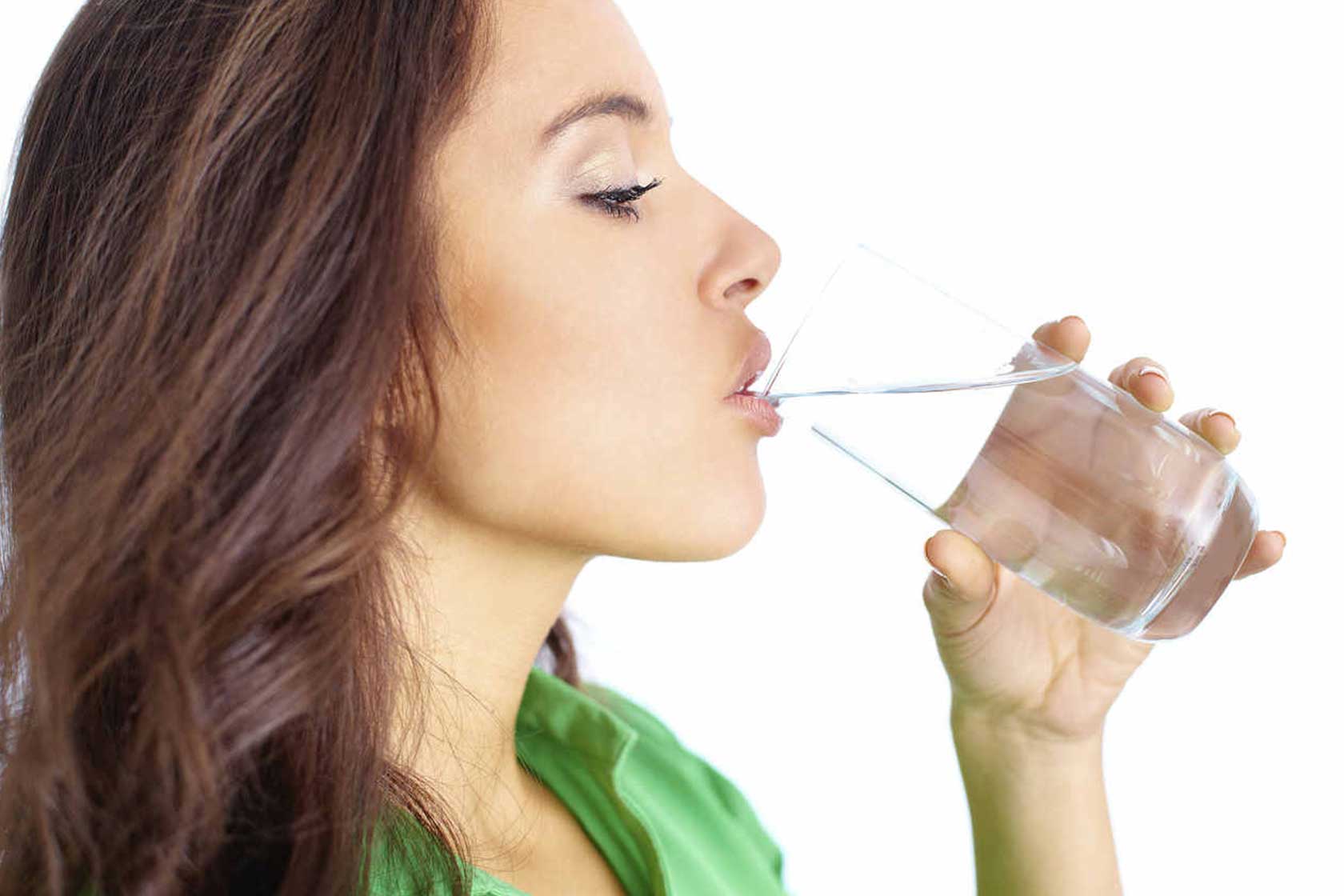 A woman drinking a glass of water.