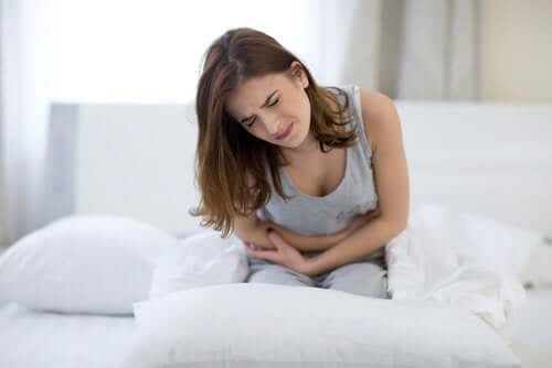 A woman clutching her stomach.