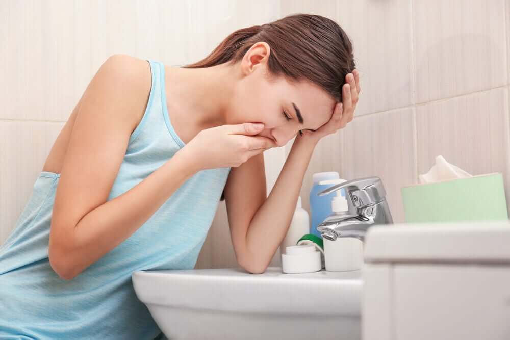 A woman being sick.