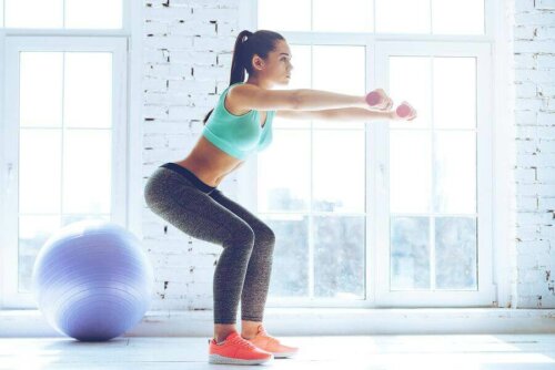 A woman doing some squats which are great for toning your legs.