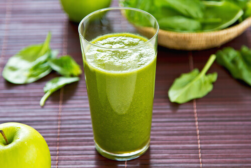 A cup with a smoothie that includes chard.