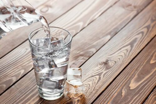 Someone pouring some water into a glass.