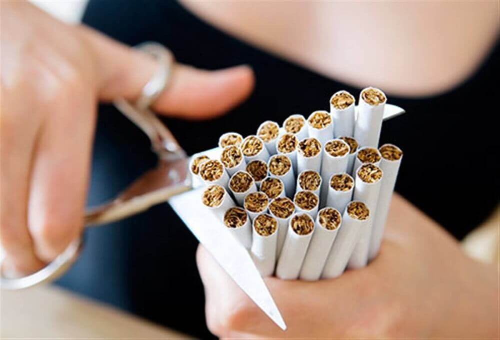 A woman cutting cigarettes.