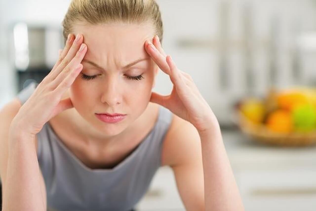 A woman with a headache.