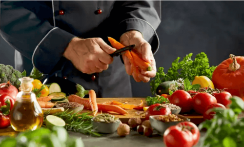 A person peeling carrots.