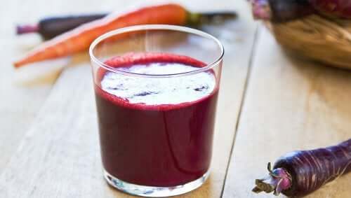 A glass of fresh beet and carrot juice.