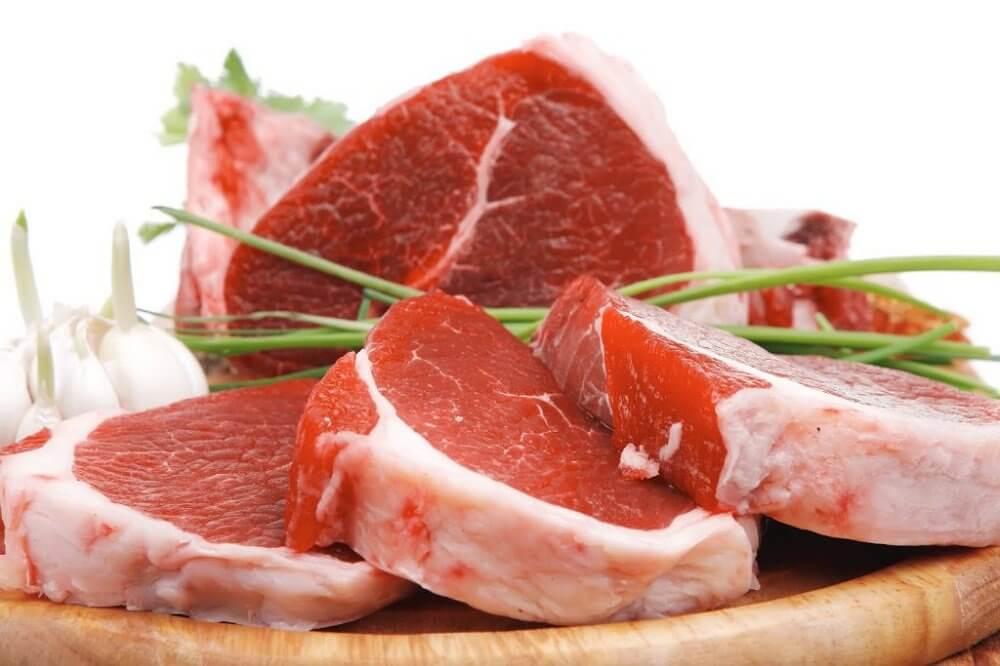 Some beef on a wooden cutting board.