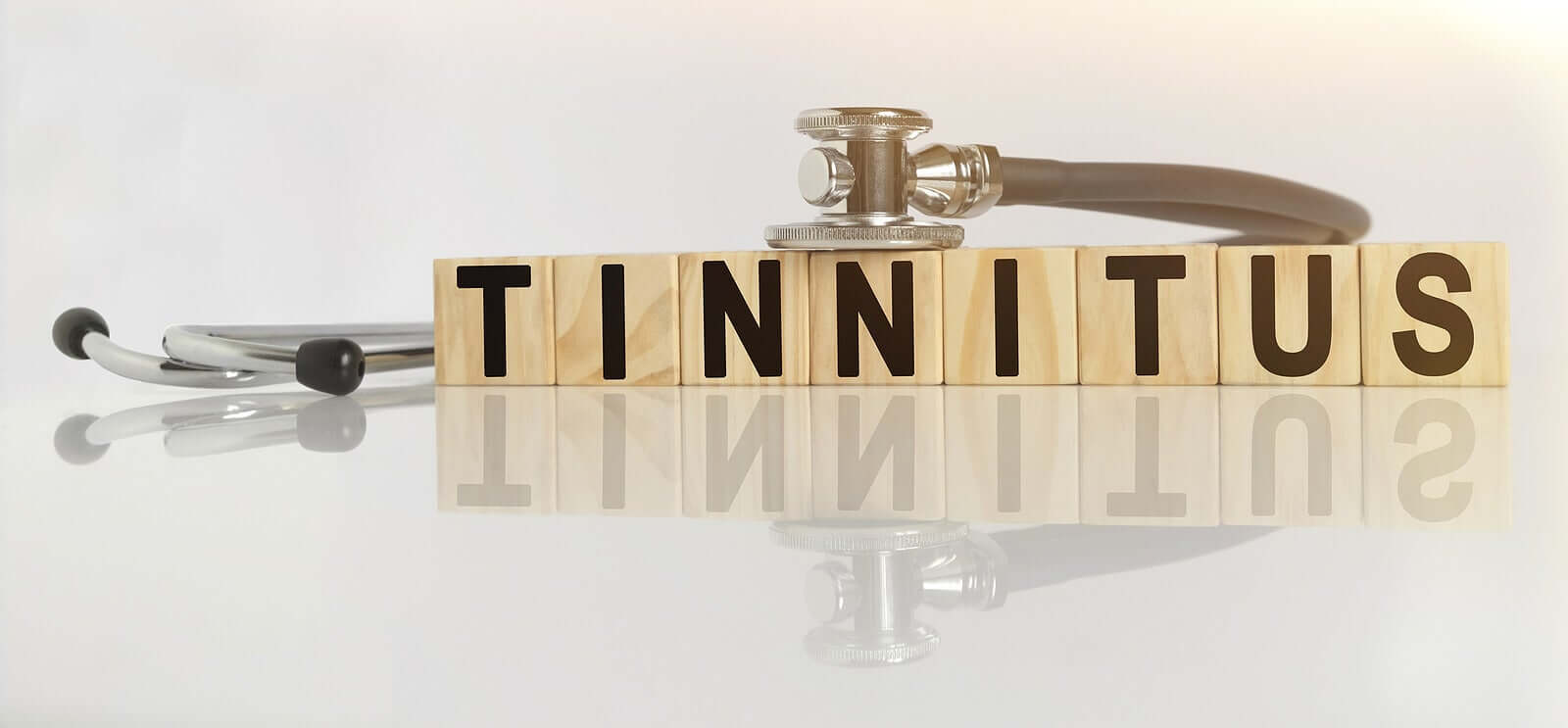 Wooden blocks that read "tinnitus".