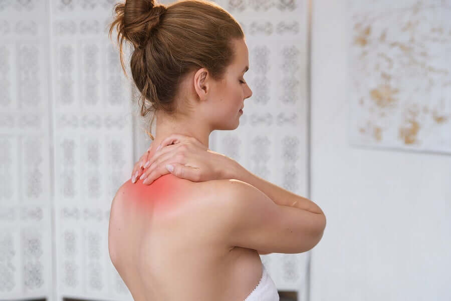 A woman with her hands on the back of her neck.