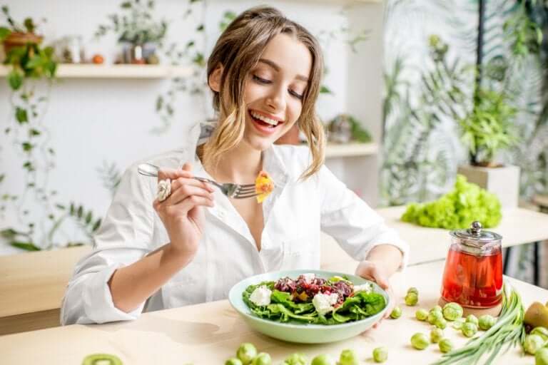 A woman eating a salad.