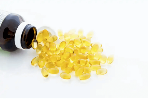 A spilled bottle of cod liver oil capsules.