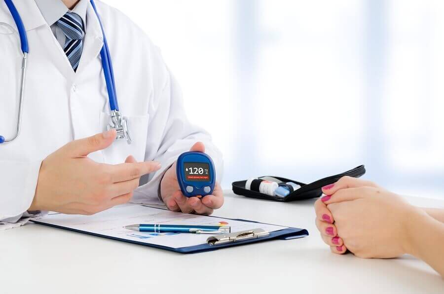 A doctor showing a glucometer to a patient.