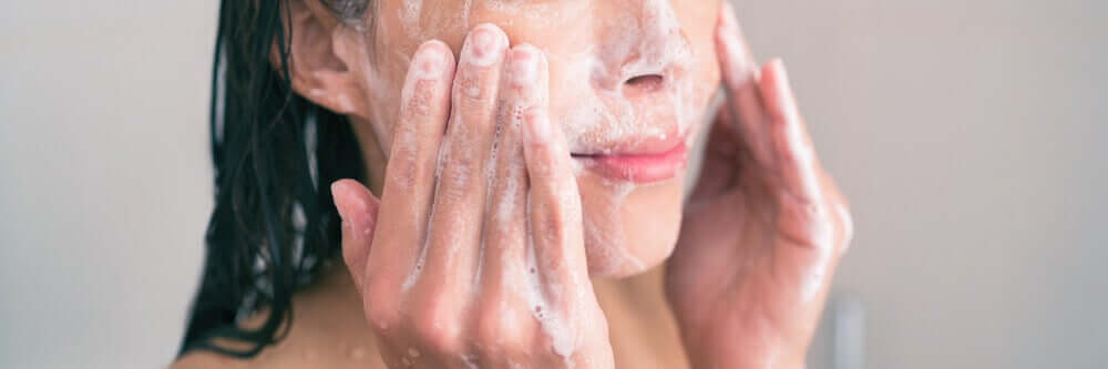A woman exfoliating her skin.