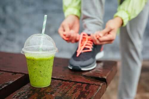 A runner getting ready for a run while drinking a pineapple-celery shake.