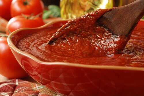  homemade tomato sauce with a wooden spoon