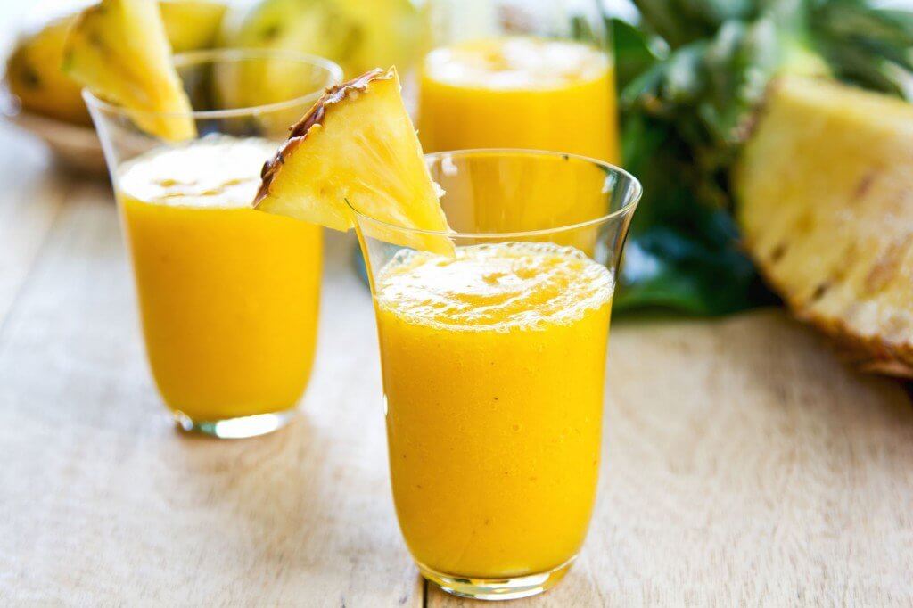 Some glasses with pineapple ginger smoothie.