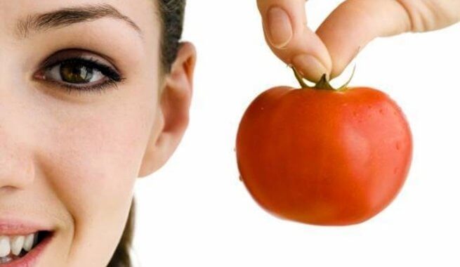 a woman holding a tomato