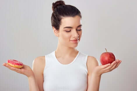 A woman deciding on an apple.