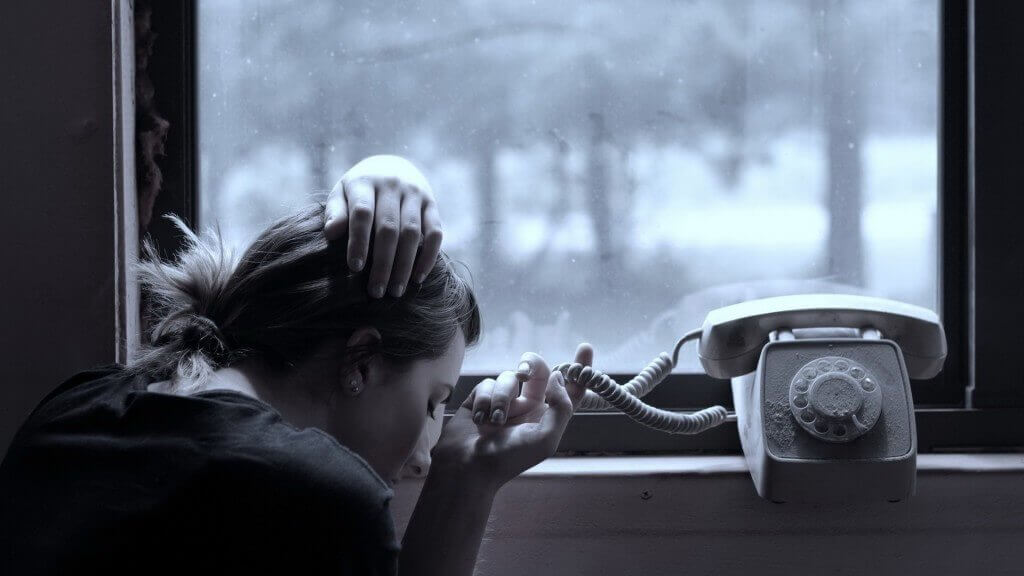 woman waiting by the phone