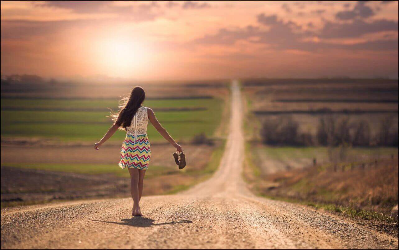 woman walking by herself down a path
