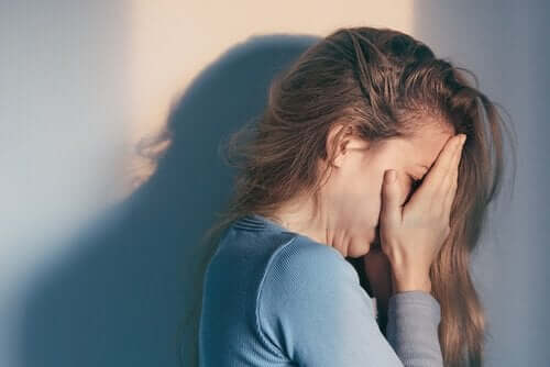 A woman crying because she's a victim of verbal abuse.