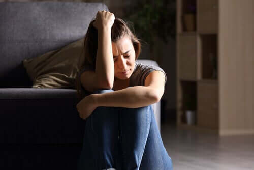 A woman crying on the floor.