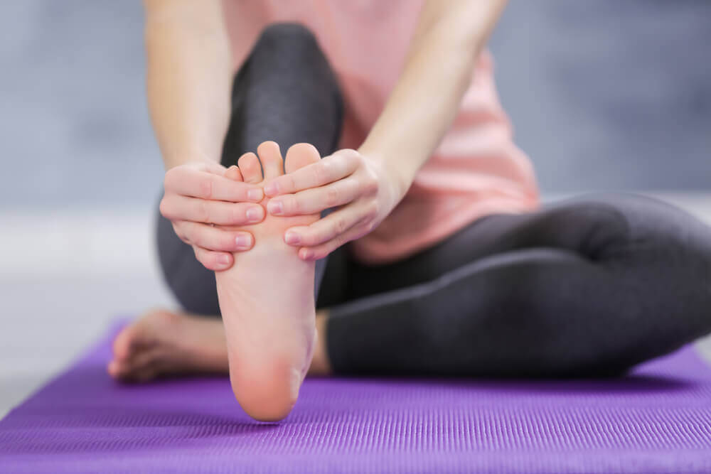 Person stretching their feet during yoga