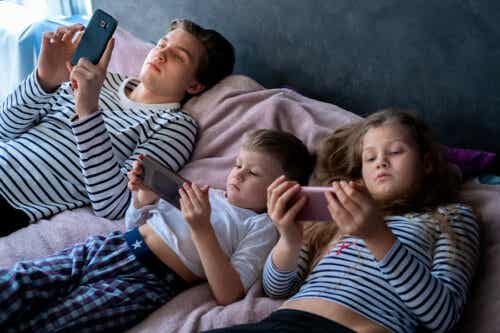 Children and teens using electronic devices in bed.