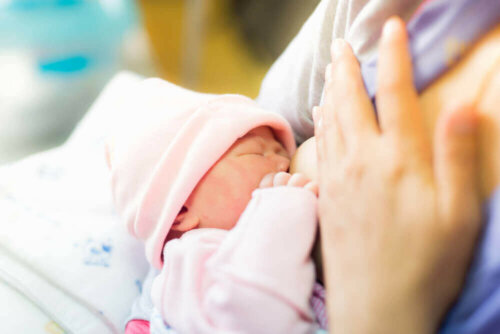 mother breast feeding a baby