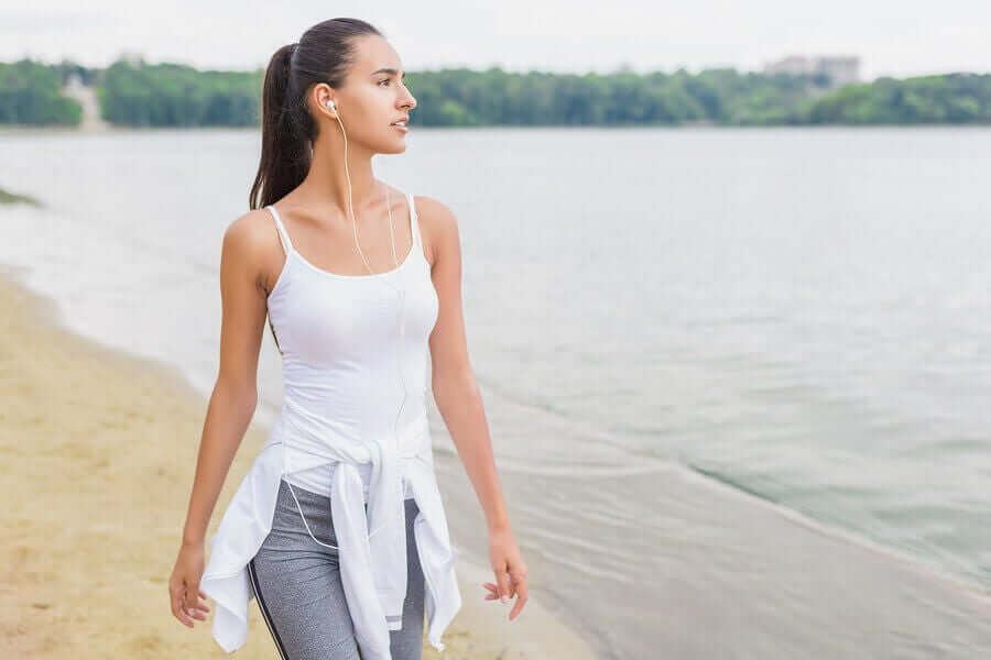 A woman walking along the beach.