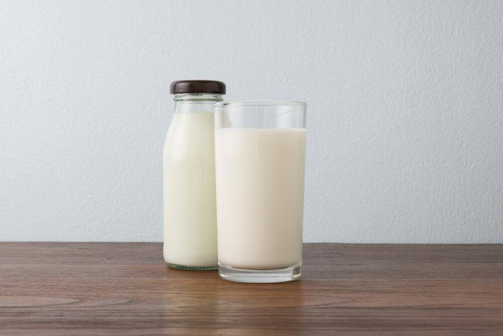 a glass and bottle of whey