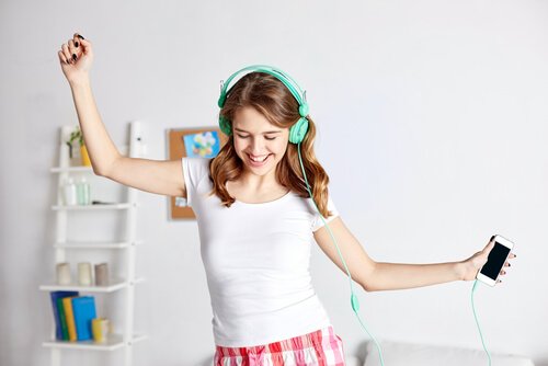 A girl dancing with headphones.